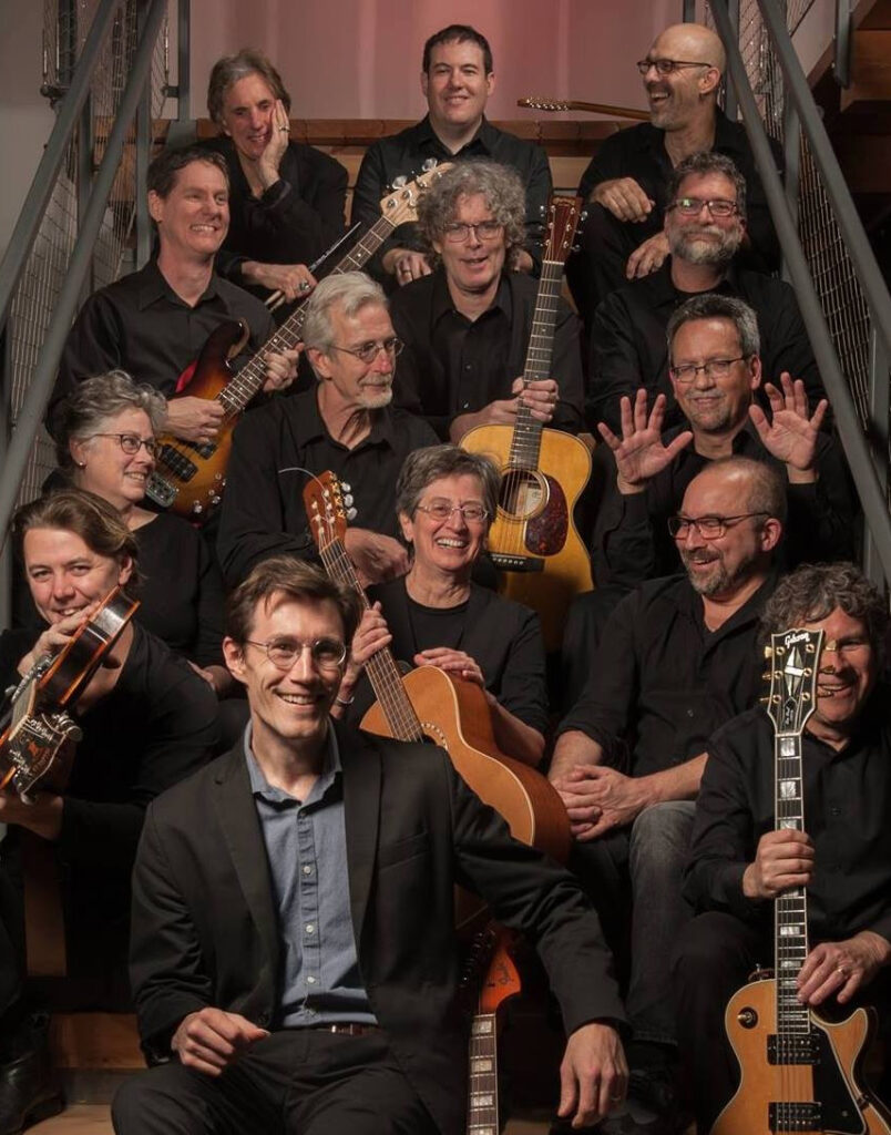 group photo of Happy Valley Guitar orchestra photographed on staircase